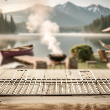 Wooden table with copy space and blurred summer barbecue background