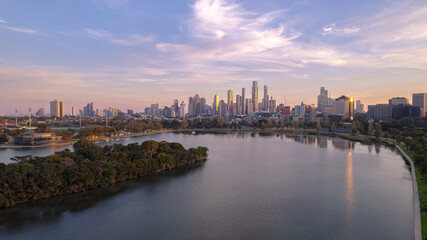 Fototapeta premium Sunrise view of Yarra river and Melbourne skyscrapers business office building with evening skyline in Victoria, Australia