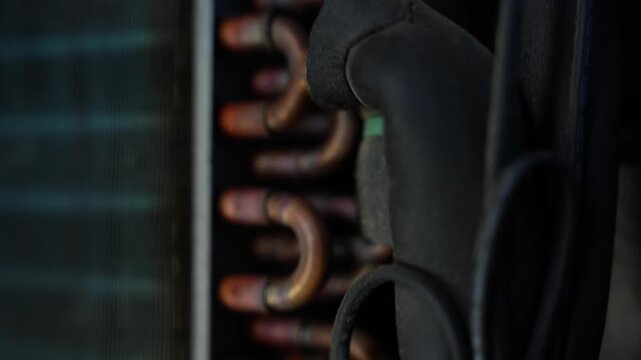 Copper cooling pipes and black insulation inside an air conditioner or refrigeration unit, Close-up of cooling pipes in air conditioner unit