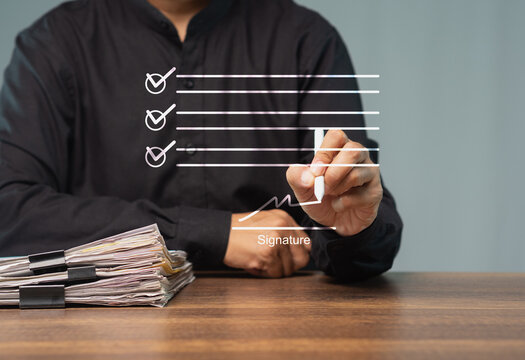 Left-handed person signing digital document on virtual interface