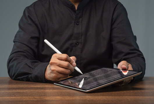 Person signing digital document on tablet with stylus