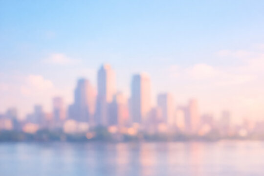 Blurred city skyline at sunrise. Abstract urban background with soft light