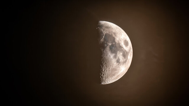 Half moon glowing in dark night sky for astronomy background
