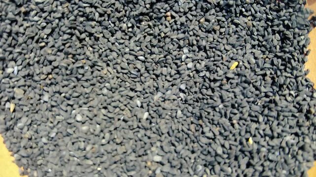A close up full frame view of a large pile of black cumin seeds