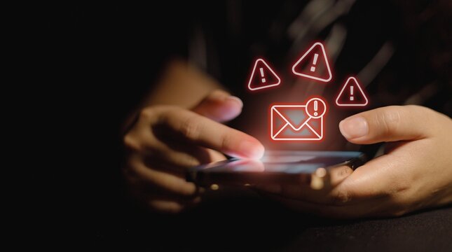 Digital security alert person receiving a notification on their smartphone about a potential spam or phishing email with multiple warning signs in the background