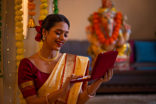 Portrait of a happy Maharashtrian woman in traditional dress holding a jewellery box on the occasion of Ganesh Chaturthi