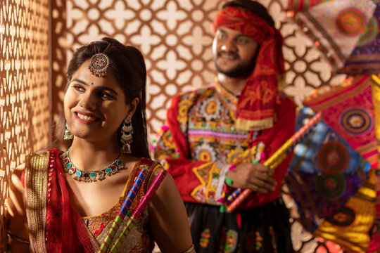 Portrait of Gujrati couple with dandiya sticks