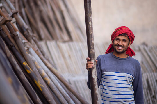A DAILY WAGE LABOURER STANDING AND LOOKING AT CAMERA