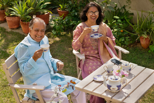Top angle view of happy Mature couple having tea together in garden