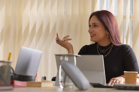 Portrait of businesswoman discussing with her colleague about a project in office