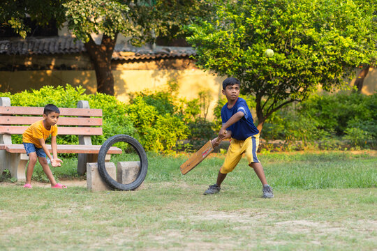 Portrait of boy playing cricket in the park