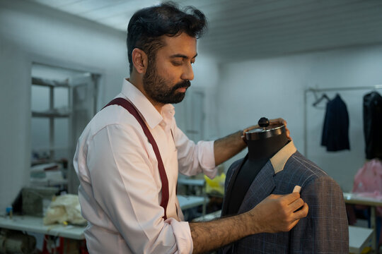 Checking measurements of a half-done jacket 