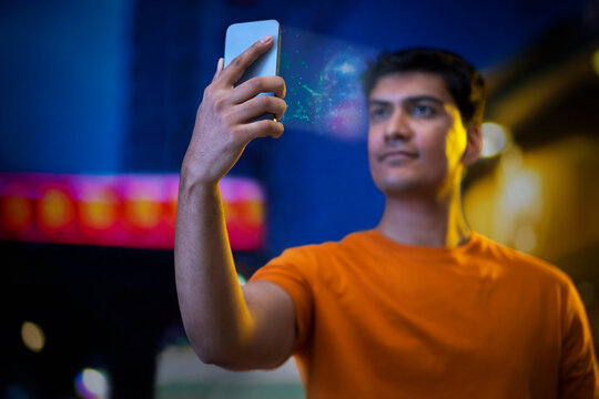 Young man using face recognition software via smartphone