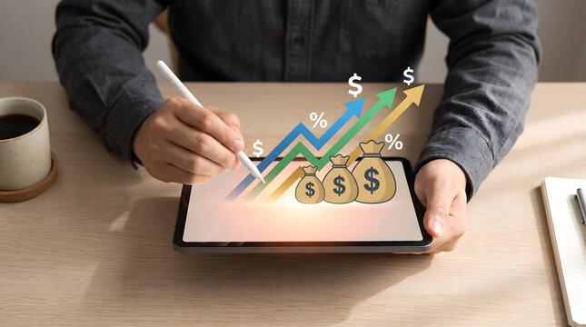 Financial growth and investment success concept: Businessman analyzing upward profit graph and money bags on digital tablet, Wealth management and ROI: Hand using stylus on tablet with rising arrows,