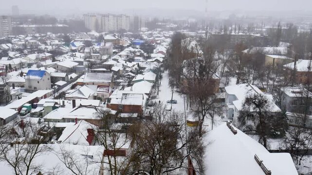 Voronezh, Russia, January 3, 2026: Winter residential area of ​​Voronezh with private sector and multi-story buildings, view from above