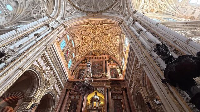 Step into a world of architectural wonder as you gaze at the stunning arches and red-and-white patterns inside the Great Mosque of Cordoba. Light filters through, illuminating the beauty.