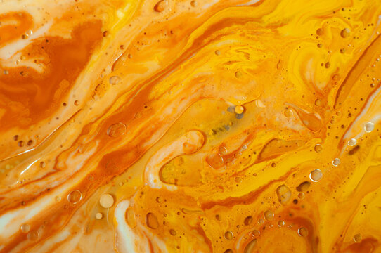 Colorful patterns form from liquid mixing in a creative art project in a studio