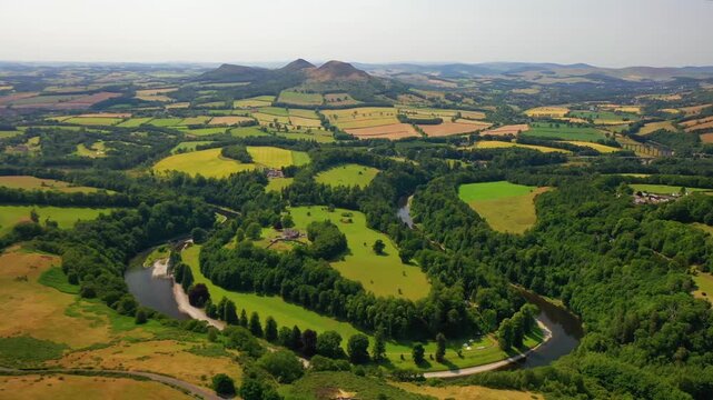 Aerial view of Eildon Hills and winding river Tweed in Scottish Borders landscape.
