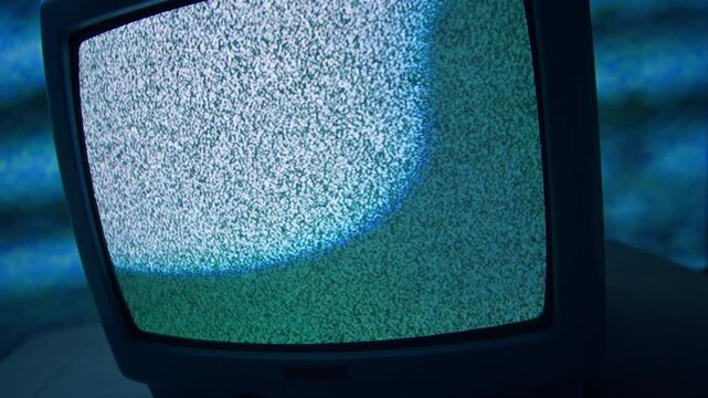Retro TV, vintage television In a nostalgic setup, a retro TV displays grain on screen, scary halloween night device good for chroma key and green screen.