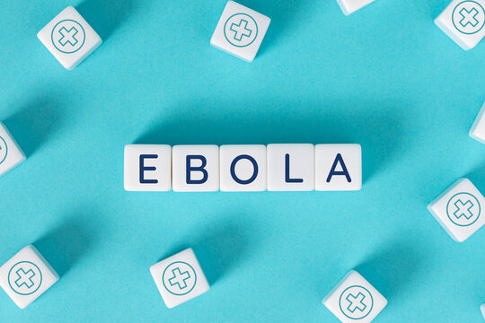Ebola word on blocks surrounded by medical cross icons on blue background