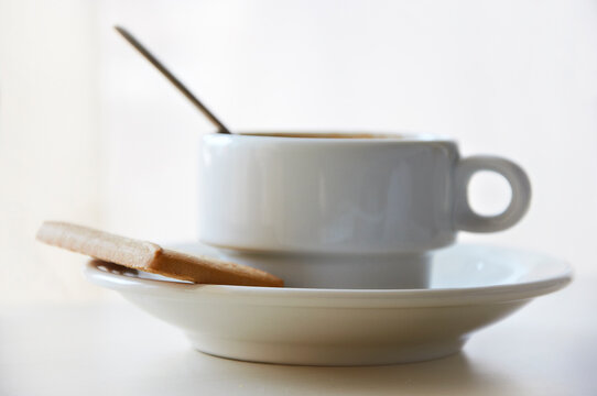 Close-up of a cup of coffee and a cookie