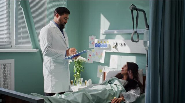 Doctor in white robe examines woman lying in bed in hospital