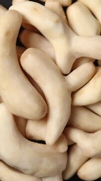 A pile of fresh peeled White Turmeric slowly rotating, Top view shot