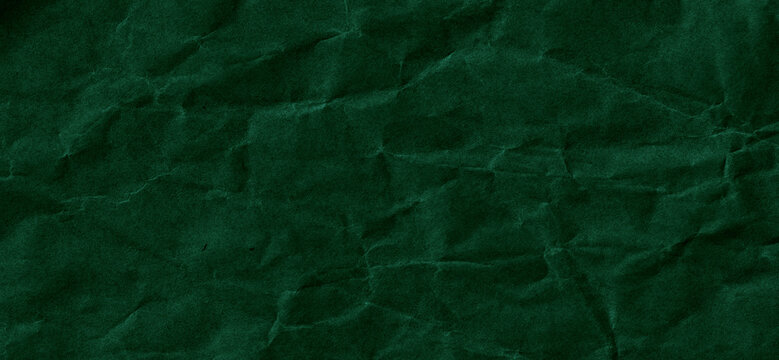 Dark green crumpled paper texture with a matte handcrafted finish. High resolution abstract background ideal for branding, design and creative projects.