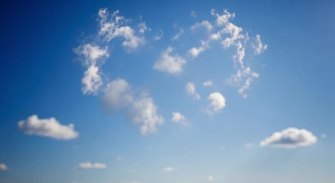 Heart shaped cloud formation floating in a bright blue summer sky representing love and peace in motion video footage
