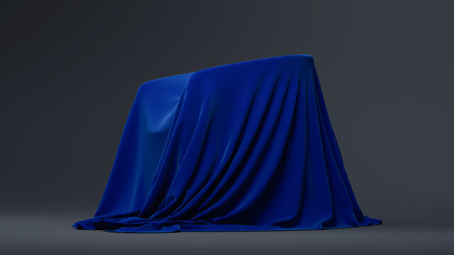 A blue, textured cloth-covered object sits on a dark gray surface against a neutral background. Copy space. 