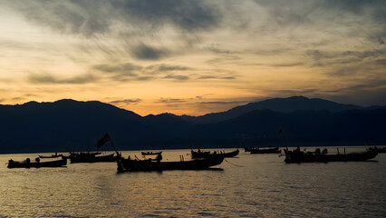 Obraz premium Boats at Tarbela Lake during suset, Tarbela Lake, Pakistan
