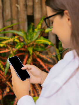 Woman using smartphone outdoor in natural setting