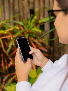Woman using smartphone outdoor in natural setting