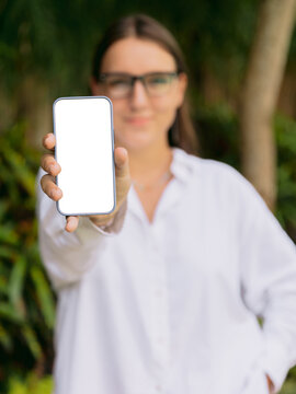 Woman showing blank smartphone screen for technology concept
