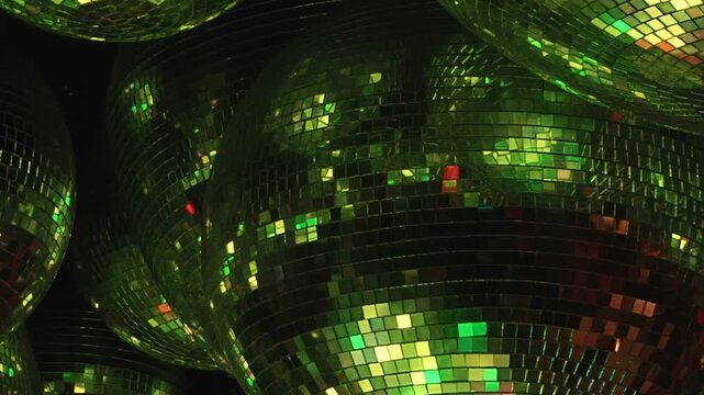 Mirrored spheres illuminate the darkness, catching brilliant blue, red, and gold lights. A lively, dynamic spectacle unfolds, transforming a nocturnal gathering into a vibrant dance celebration.