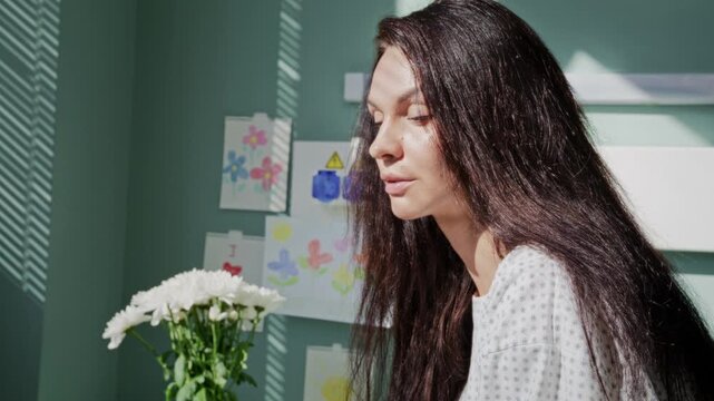Sick woman breathes heavily as suffers from pain in hospital ward