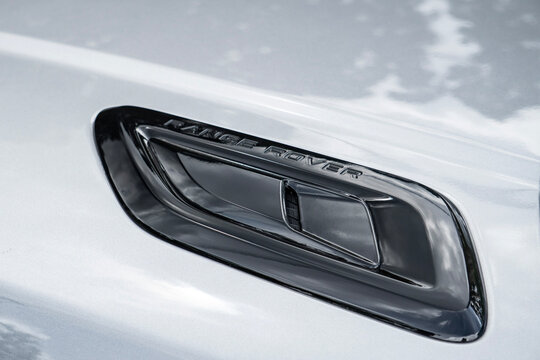 Silver Land Rover Range Rover Sport hood vent lettering close up, Luxury SUV exterior bading details