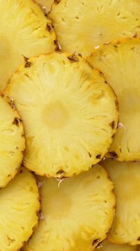 Sliced pineapple fruit. rotating. Vertical footage