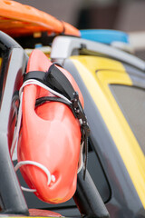 Orange rescue buoy strapped on patrol vehicle The Concept of safety and emergency © VicVaz
