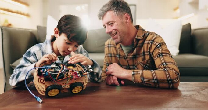Dad, child and high five with toy car in home for assembling parts, bonding or fun activity together. Father, son or success with electrical motor vehicle for junior engineering or robotics in house