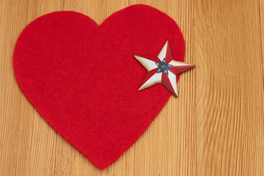 Blank red heart with American flag star on a wood desk for military appreciation
