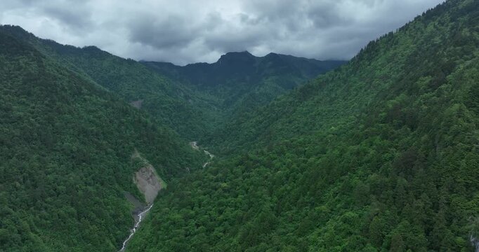 Aerial footage of beautiful high altitude grassland and mountain landscape	