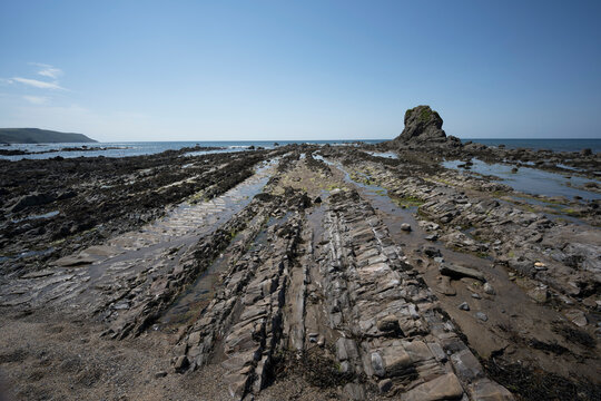 Impressive rocks surrounding Black Rock on Widemouth Bay beach