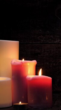 Candle burning in the dark. Candlelight in the night. Closeup. Vertical footage