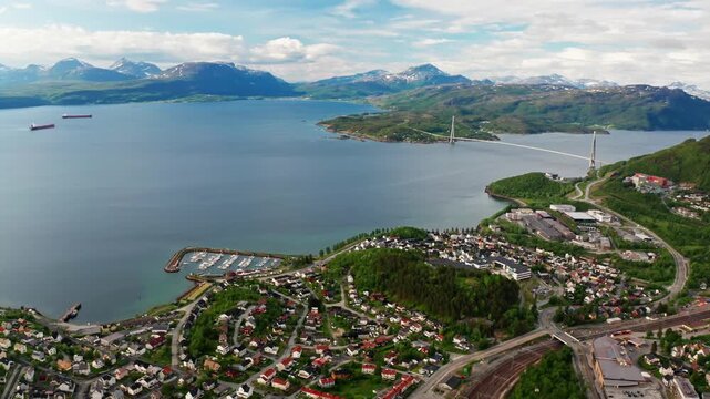 Aerial view of Narvik coastal town with H&aring;logaland bridge over scenic fjord.