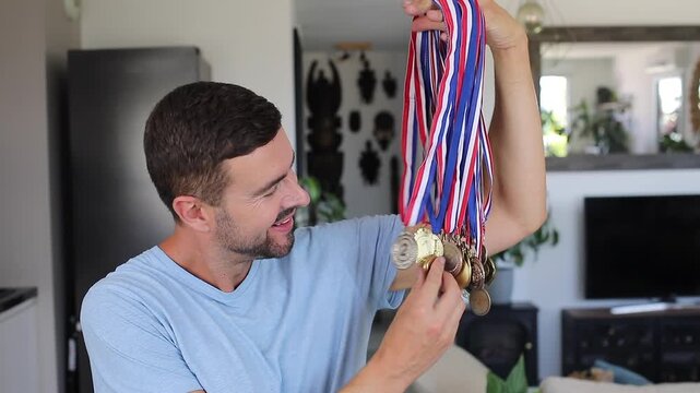 Sporty man showing many medals
