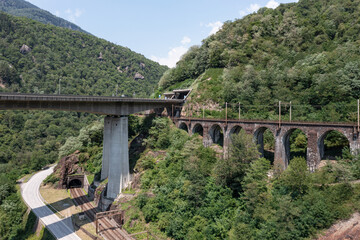 Naklejka premium Highway bridge in Ticino between Giornico and Lavorgo, with an aerial shot you can see all the communication routes, railway, highway and old cantonal road
