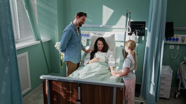 Family stays near recovering mother in hospital ward together