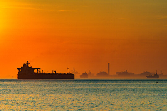 Large oil tanker sailing in fos-sur-mer harbor at sunset