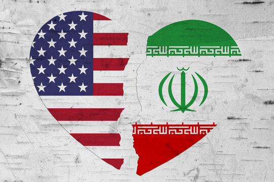 USA and Iran flags in a broken heart